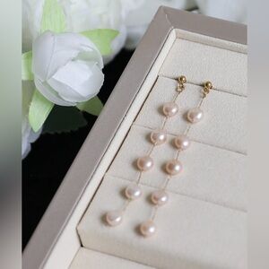 Freshwater pearls dangle elegantly on long linear drop earrings